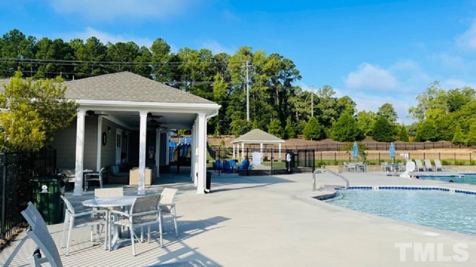674 Brook Pine Trail Apex, NC 27523 - Photo 28 of 30 a view of a patio with table and chairs with wooden floor and fence