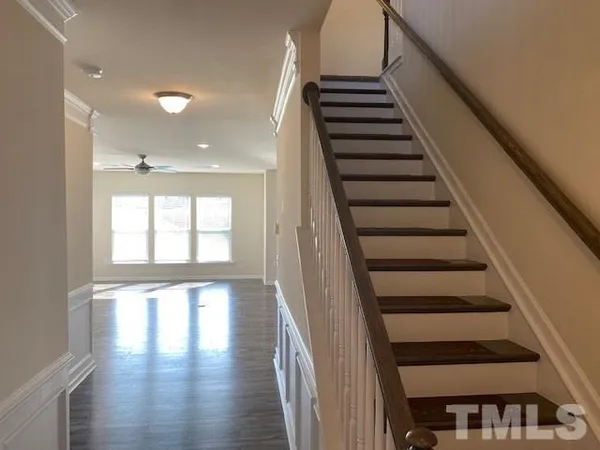 a view of entryway and hall with wooden floor