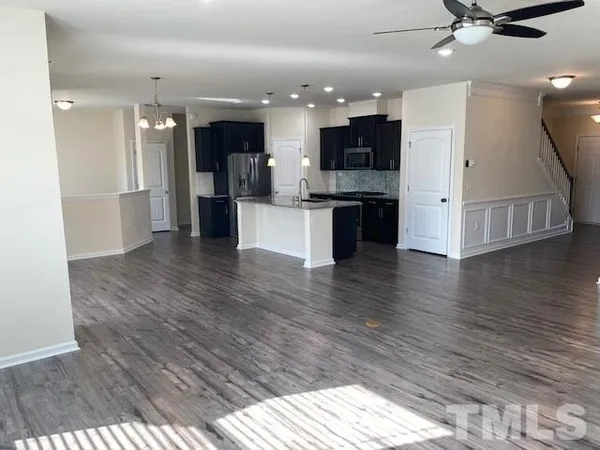 a view of kitchen with cabinets and wooden floor