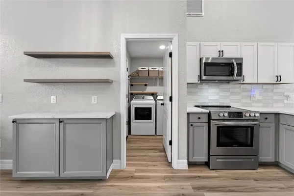 a stove top oven sitting inside of a kitchen