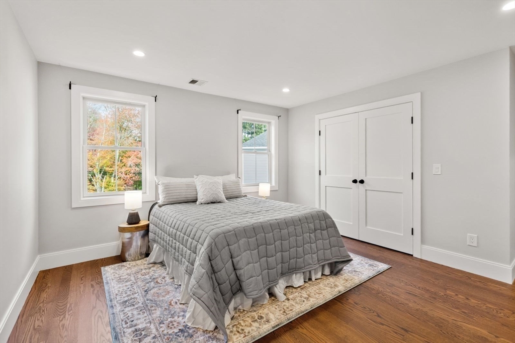 48 Graystone Lane Natick, MA 01760 - Photo 18 of 30 a bedroom with a bed and wooden floor