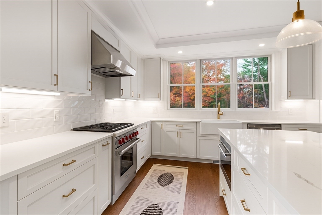 48 Graystone Lane Natick, MA 01760 - Photo 4 of 30 a kitchen with a stove a sink and a refrigerator