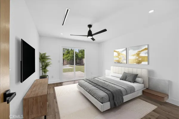 a bedroom with a large bed and a flat screen tv