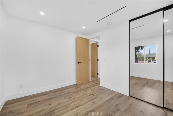 a view of hallway with wooden floor