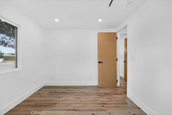 a view of room with window and wooden floor