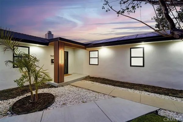 a front view of a house with garden