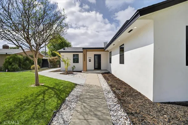 a front view of a house with garden