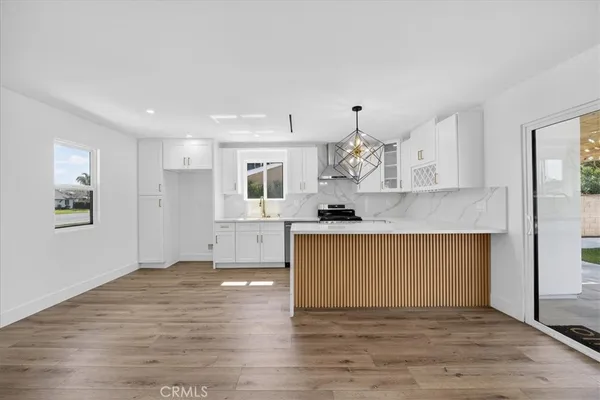 a view of kitchen with granite countertop cabinets and wooden floor