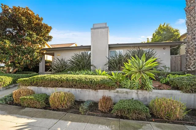 a view of a garden with a building in the background