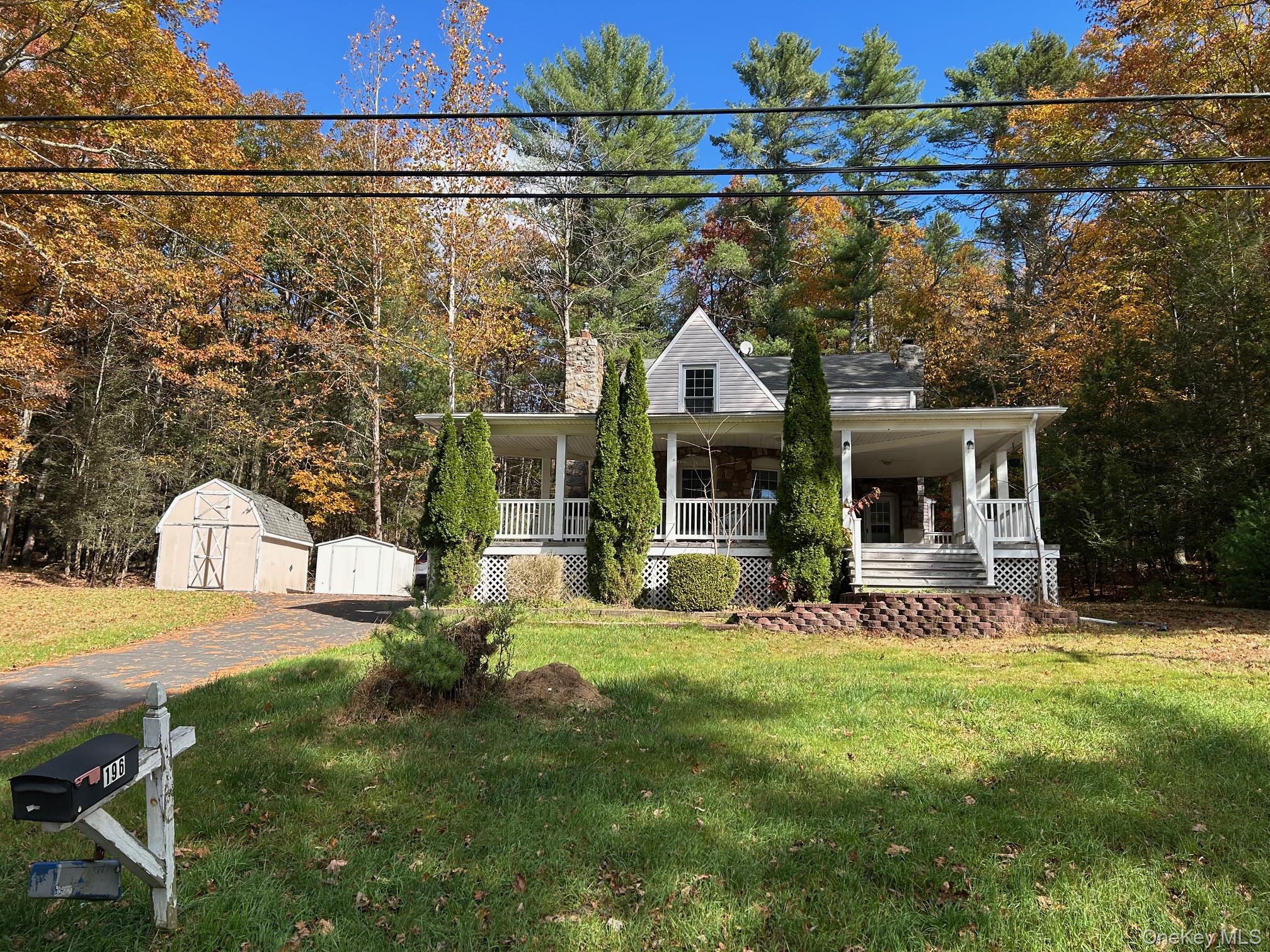 a view of a house with backyard porch and sitting area