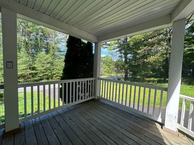 a view of balcony with wooden floor