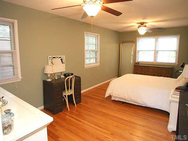 1108 Hardimont Road Raleigh, NC 27609 - Photo 11 of 25 a bedroom with a bed and a chair