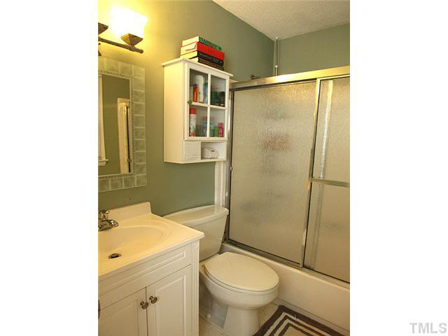 1108 Hardimont Road Raleigh, NC 27609 - Photo 14 of 25 a bathroom with a sink toilet and shower