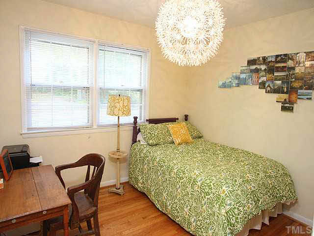 1108 Hardimont Road Raleigh, NC 27609 - Photo 15 of 25 a bedroom with a bed and a table with chair
