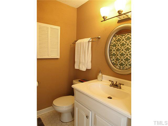 1108 Hardimont Road Raleigh, NC 27609 - Photo 16 of 25 a bathroom with a toilet sink and mirror