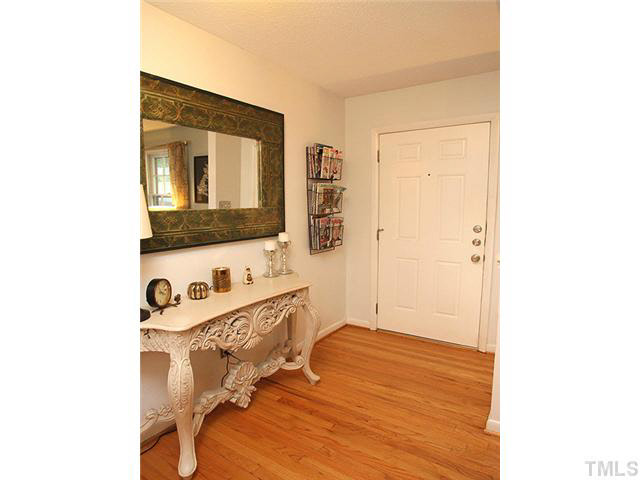 1108 Hardimont Road Raleigh, NC 27609 - Photo 3 of 25 a room with a bed and a flat screen tv