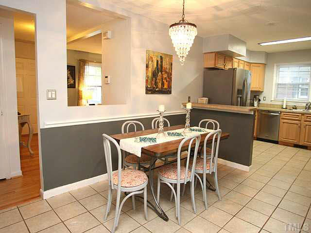 1108 Hardimont Road Raleigh, NC 27609 - Photo 7 of 25 a dining room filled chandelier and kitchen view
