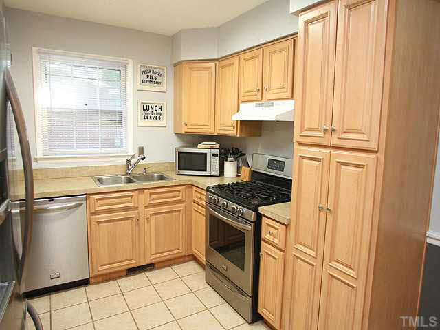 1108 Hardimont Road Raleigh, NC 27609 - Photo 10 of 25 a kitchen with a stove a sink and a refrigerator