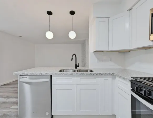 a kitchen with appliances cabinets and a sink