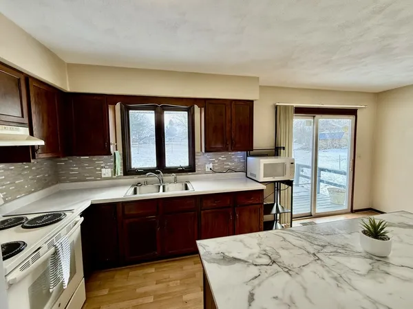 a kitchen with stainless steel appliances a refrigerator and a sink