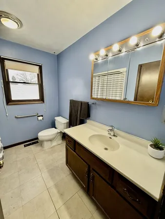 a bathroom with a sink mirror and vanity