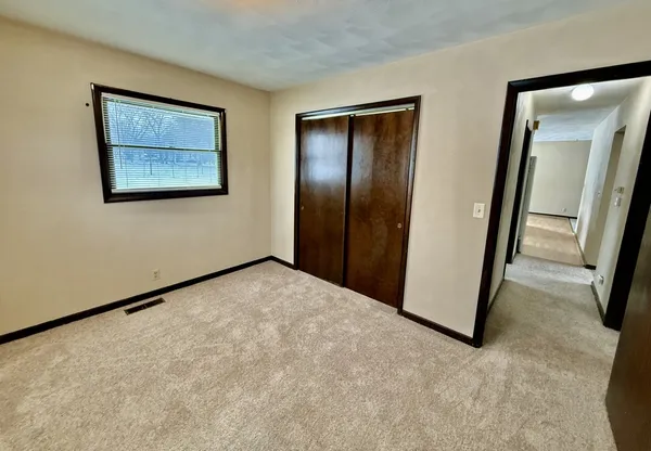 a view of a big room with a ceiling fan