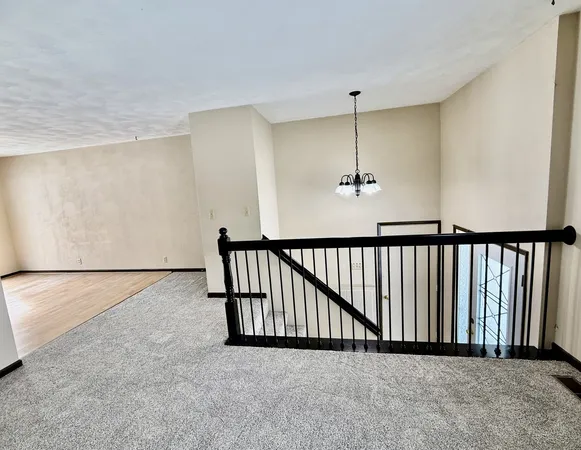 a view of a room with a ceiling fan
