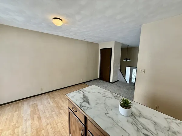 a kitchen with a sink a window and wooden cabinets