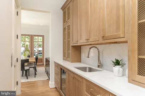 a kitchen with counter top space a sink and white cabinets