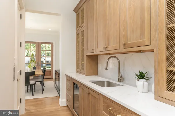 a kitchen with counter top space a sink and white cabinets