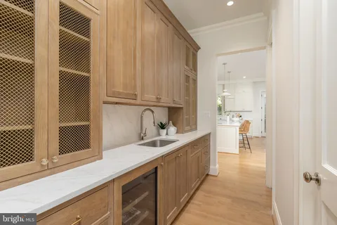 a kitchen with a sink cabinets and window