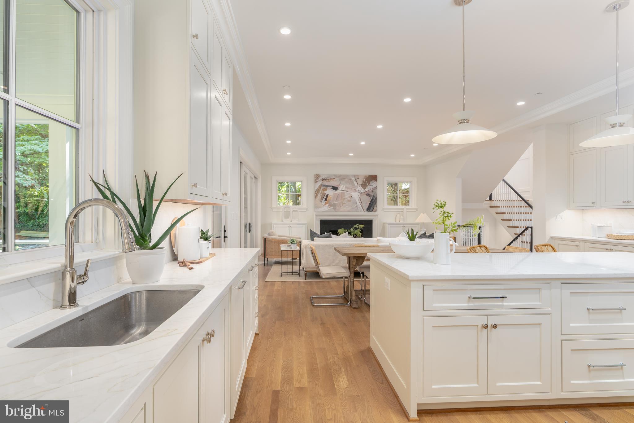 5413 Center Street Chevy Chase, MD 20815 - Photo 25 of 71 a kitchen with counter top space a sink and white cabinets