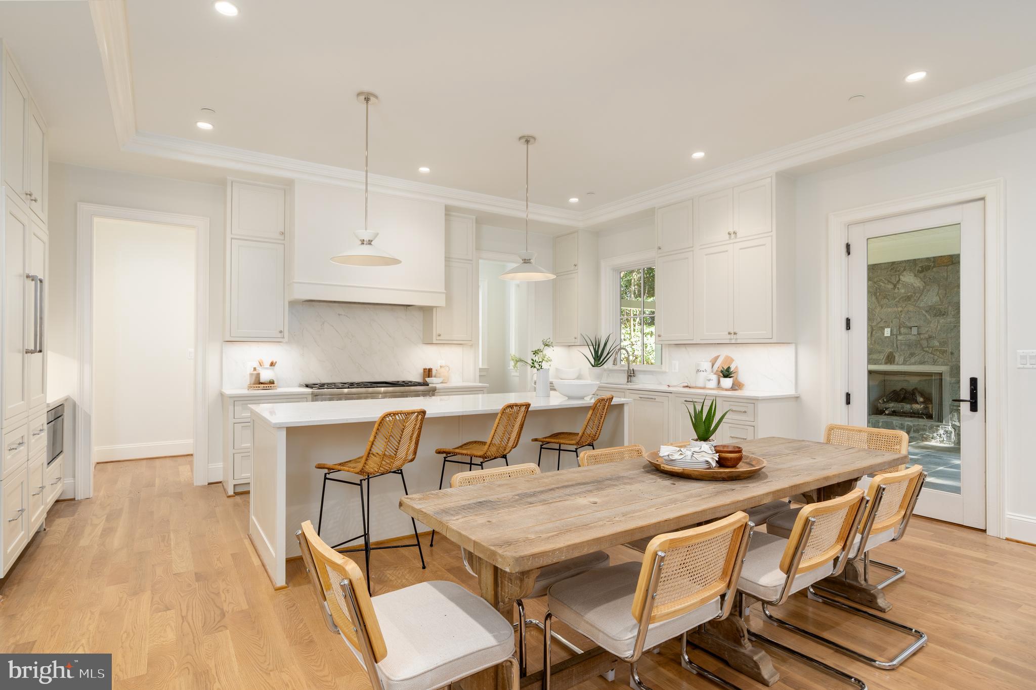 5413 Center Street Chevy Chase, MD 20815 - Photo 30 of 71 a kitchen with a dining table chairs and white cabinets