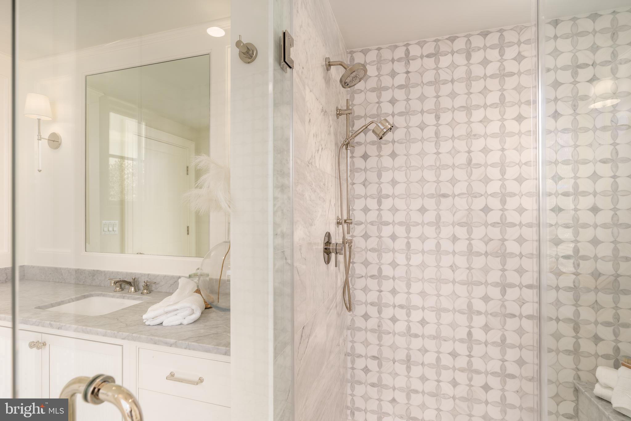 5413 Center Street Chevy Chase, MD 20815 - Photo 46 of 71 a bathroom with a sink a mirror and shower