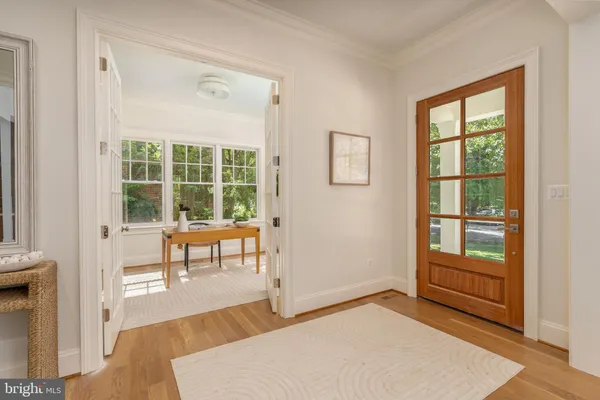 a living room with a fireplace and a floor to ceiling window