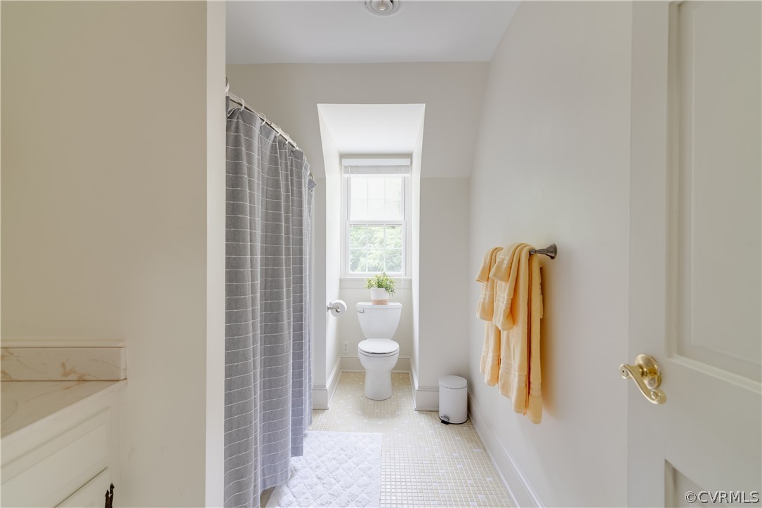 4616 Ladysmith Road Ruther Glen, VA 22546 - Photo 28 of 44 a bathroom with a granite countertop sink a toilet and a shower