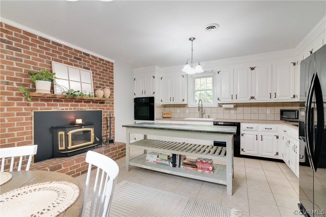 4616 Ladysmith Road Ruther Glen, VA 22546 - Photo 8 of 44 a kitchen with a stove a sink and a fireplace