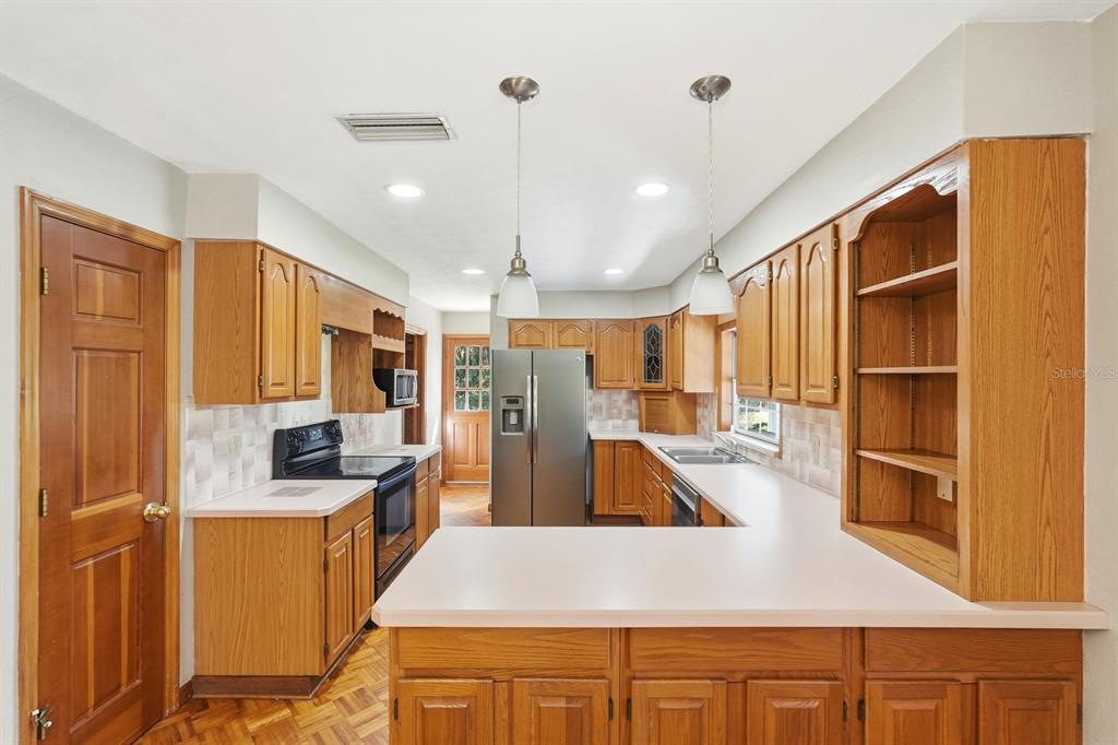404 Old Haw Creek Road Bunnell, FL 32110 - Photo 11 of 51 a view of a kitchen with kitchen island stainless steel appliances wooden floor and furniture
