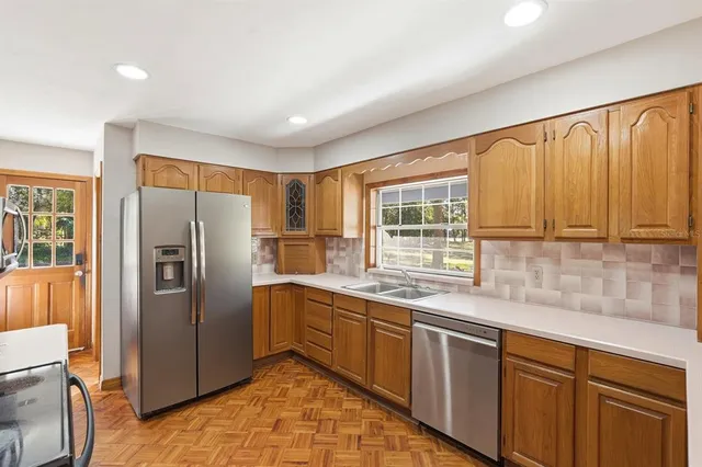 a kitchen with stainless steel appliances granite countertop a refrigerator and a sink