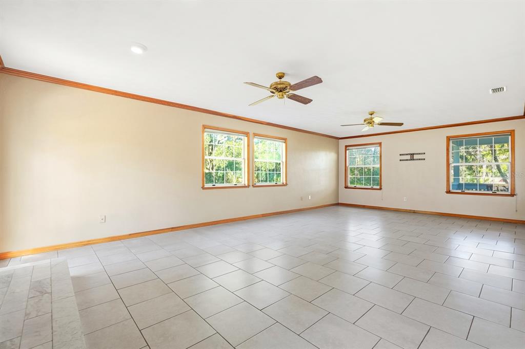 404 Old Haw Creek Road Bunnell, FL 32110 - Photo 17 of 51 an empty room with windows and ceiling fan