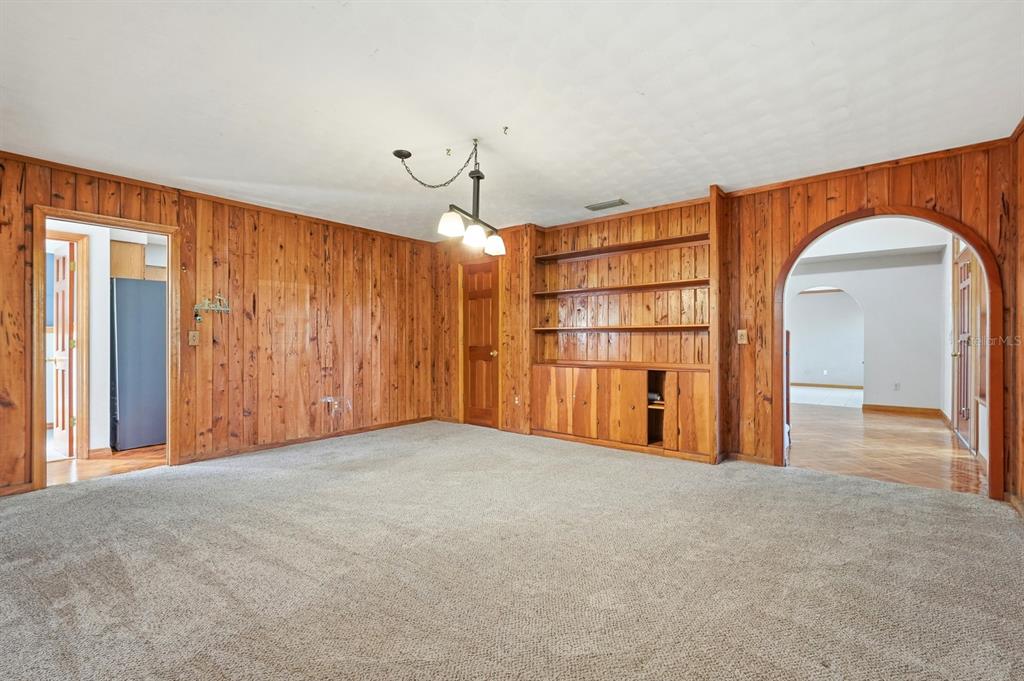 404 Old Haw Creek Road Bunnell, FL 32110 - Photo 20 of 51 a view of an empty room with a cabinet and chandelier