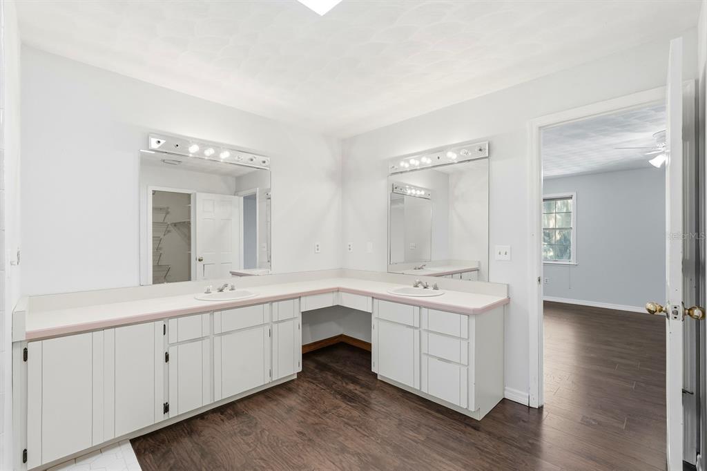 404 Old Haw Creek Road Bunnell, FL 32110 - Photo 25 of 51 a spacious bathroom with a double vanity sink a mirror and a