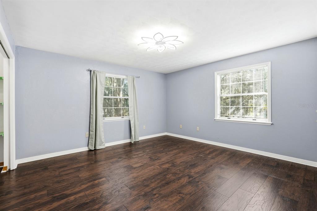 404 Old Haw Creek Road Bunnell, FL 32110 - Photo 28 of 51 a view of an empty room with wooden floor and a window
