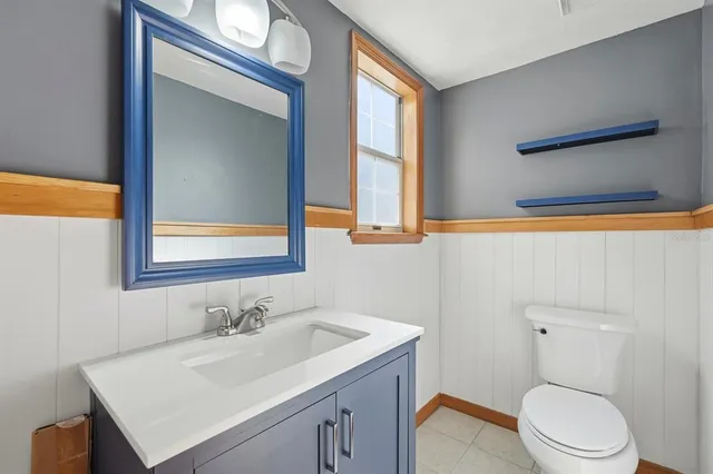 a bathroom with a toilet a sink and a mirror