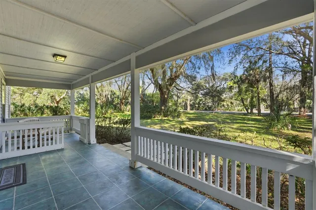 a view of a porch with wooden floor and outdoor space