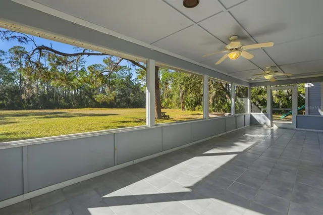 a view of swimming pool with a floor to ceiling window and an outdoor view