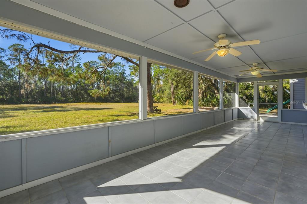 404 Old Haw Creek Road Bunnell, FL 32110 - Photo 34 of 51 a view of swimming pool with a floor to ceiling window and an outdoor view