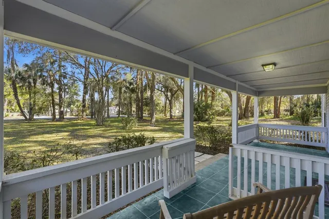 a view of a porch with wooden floor and outdoor space