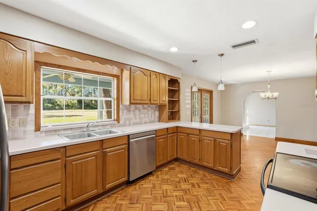 a large kitchen with kitchen island granite countertop a sink and a window