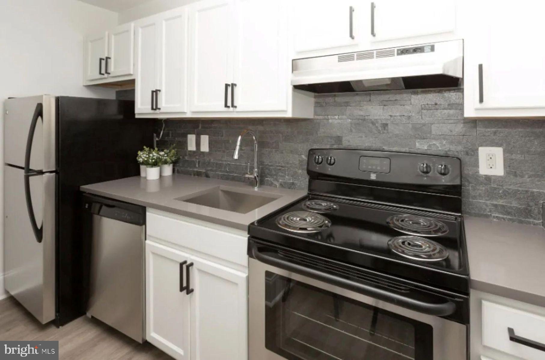 1012 North Calvert Street, Unit 3B Baltimore, MD 21202 - Photo 3 of 9 a kitchen with a stove and a refrigerator
